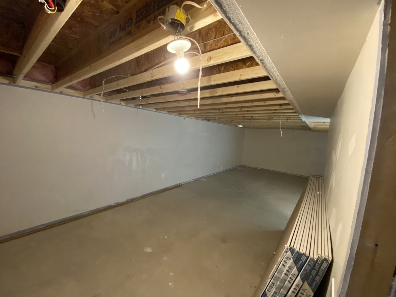 Exposed engineered floor joists during remodeling.
