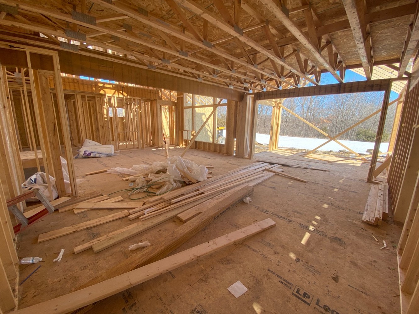 A large framed opening below exposed floor trusses.