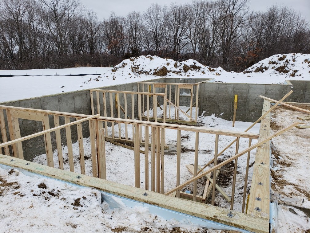 Bolted sill plates on a concrete foundation.