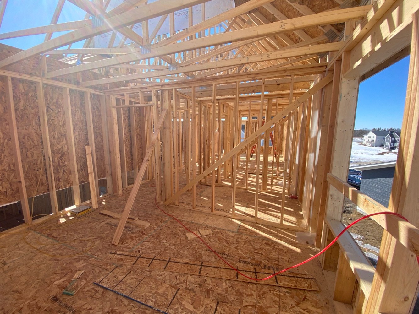Wall studs and roof trusses in an unfinished house.