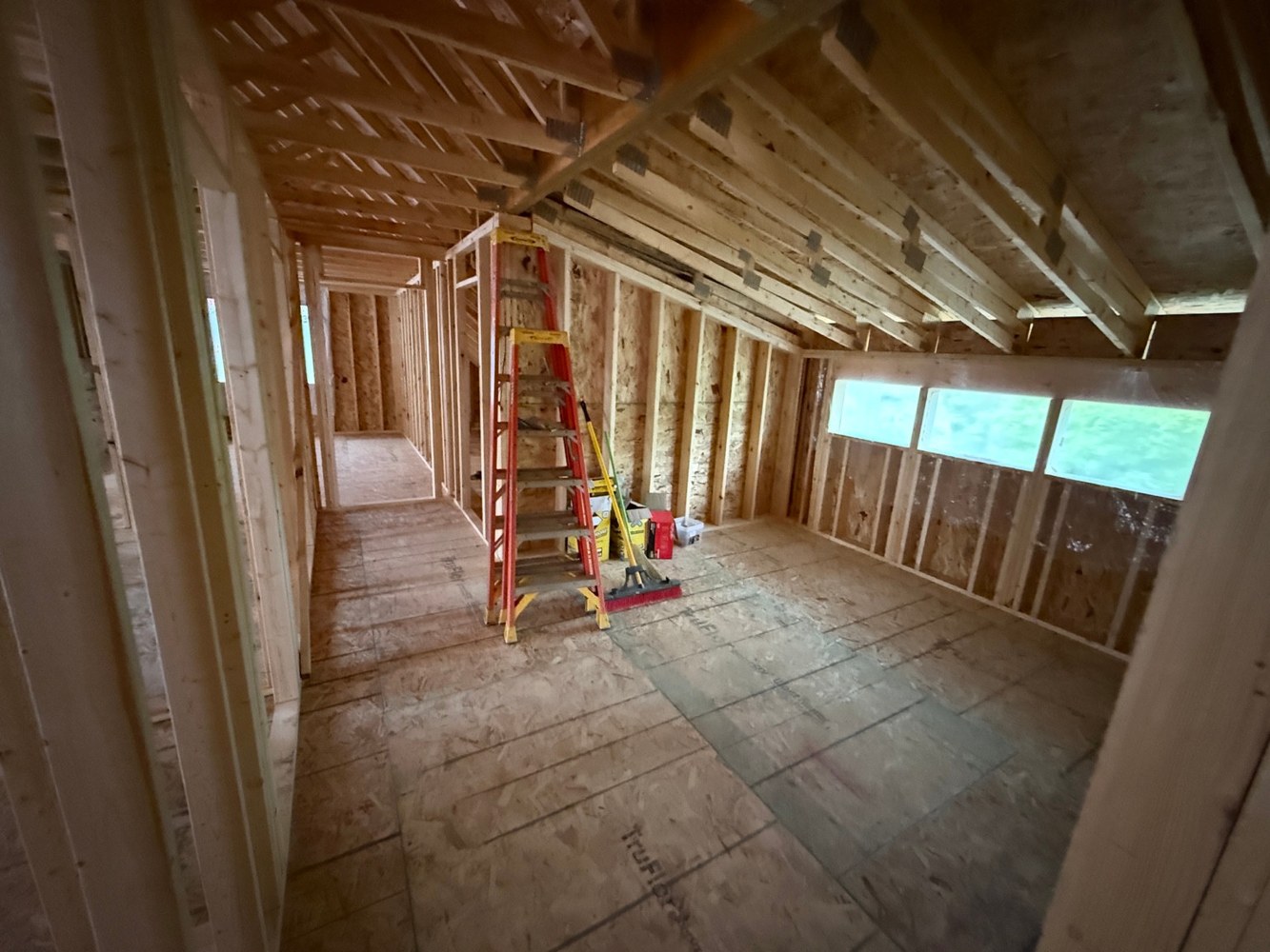 Exposed roof trusses and wall framing.
