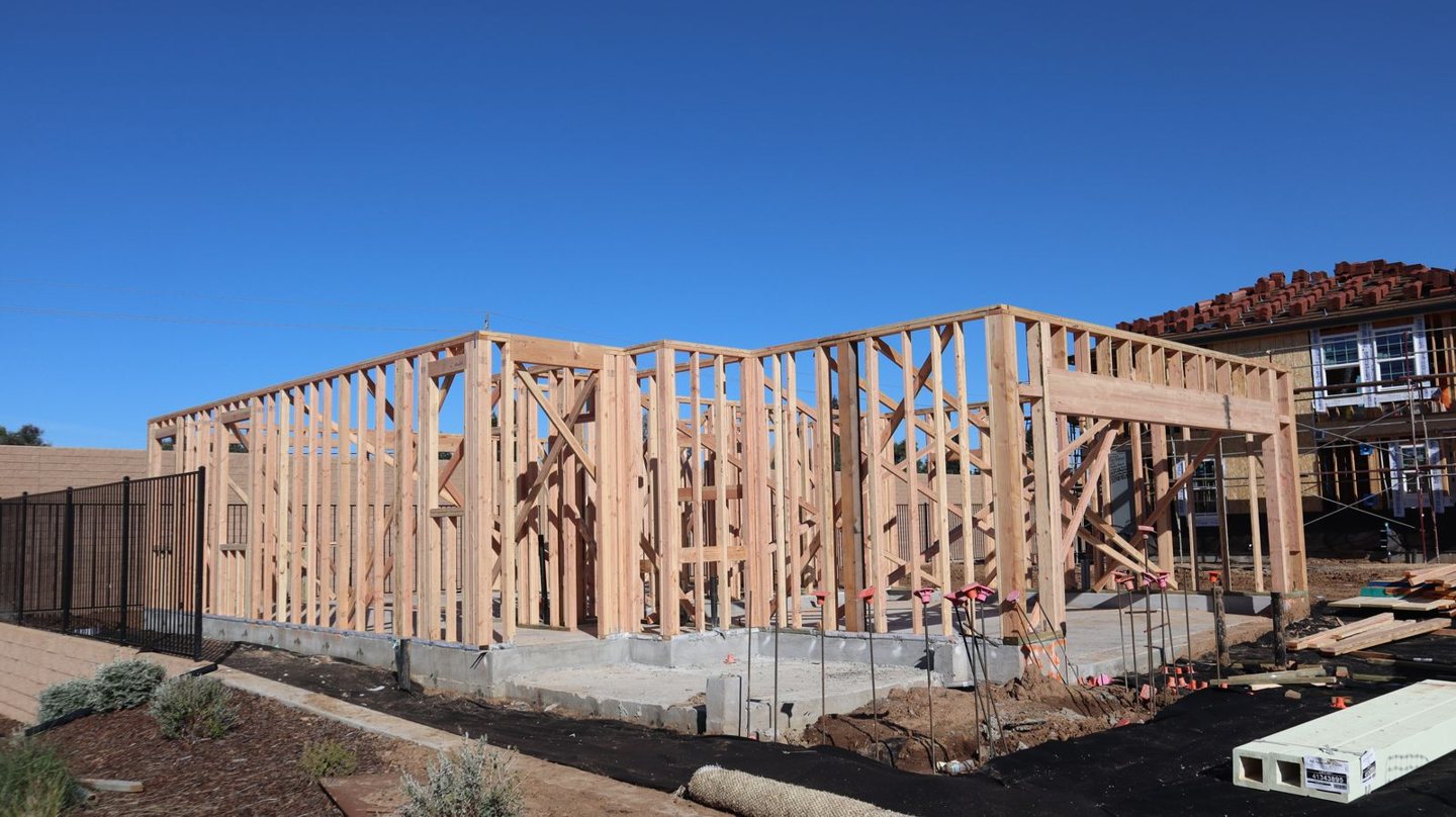 Exposed wall framing and header at a residential construction site.