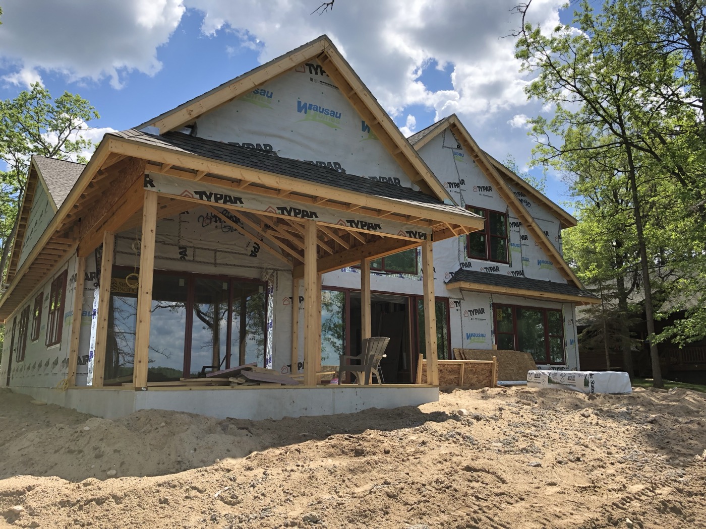 Exposed porch posts, beams and roof framing during construction