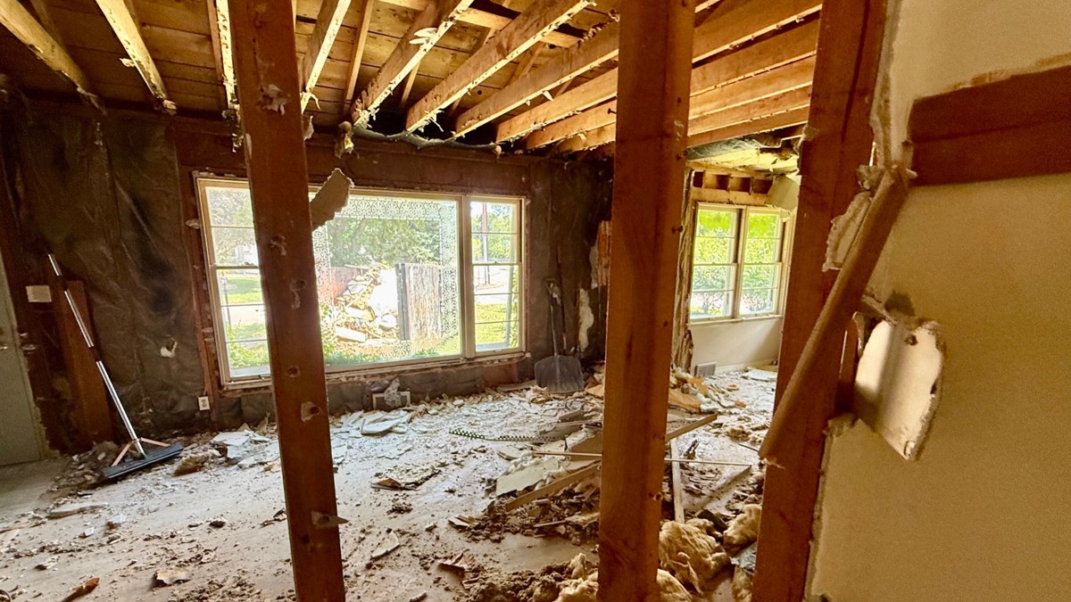 An interior opened to expose walls and ceiling framing during remodeling.
