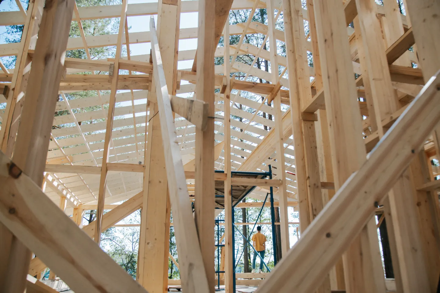 Representative stock photograph of wood framing under construction.